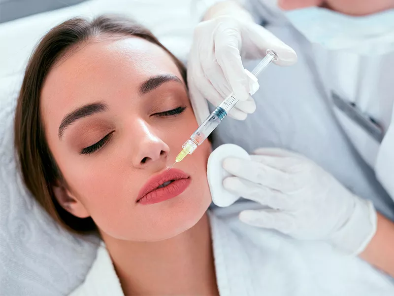 Rosto com preenchimento de ácido hialurônico destacando os lábios e maçãs do rosto